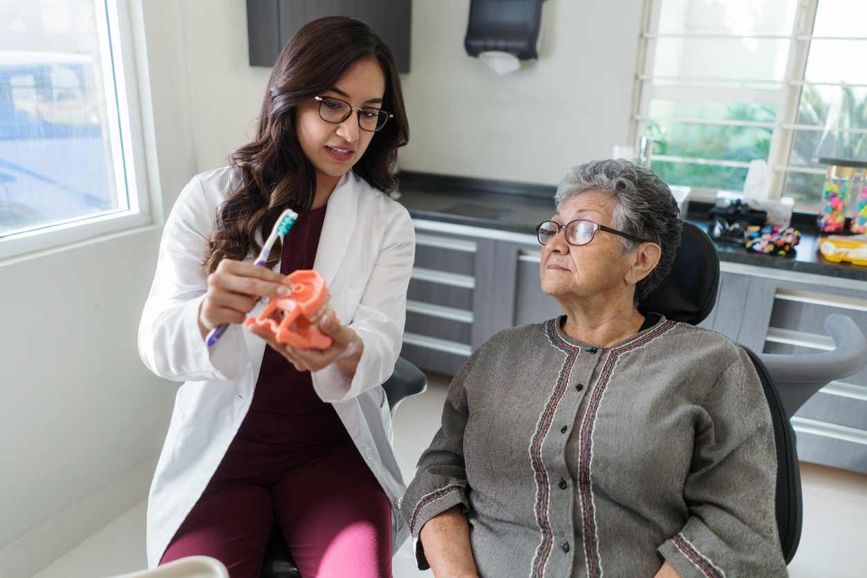 Dentist showing dental model to patient